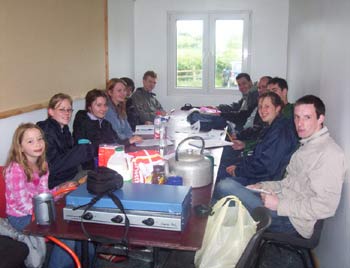 The students taking shelter in the portacabin during a heavy shower